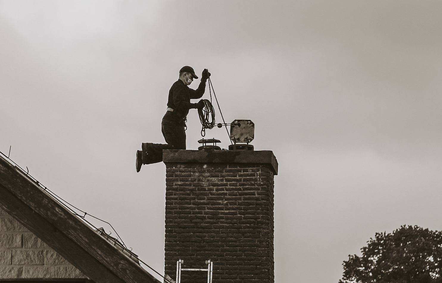 man kneeling on chimney
