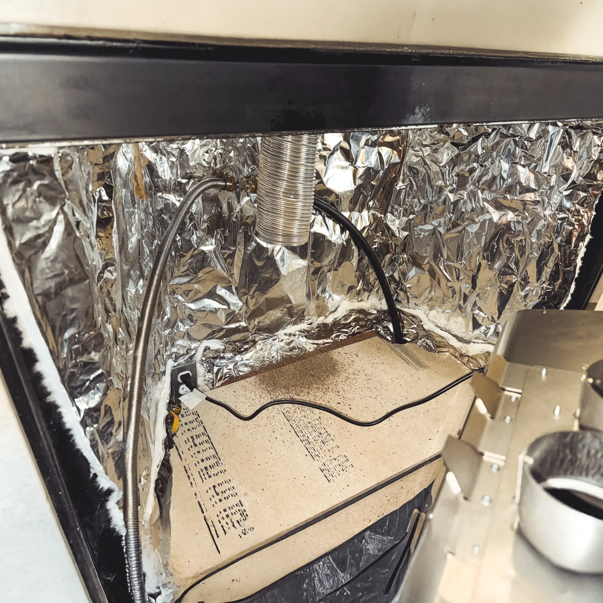 Foil-faced insulation installed inside a modified prefabricated fireplace behind a gas insert in Collegeville, PA