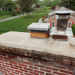 Original chimney cap and masonry crown before installation of a new stainless steel liner and chimney cap in Norristown, PA
