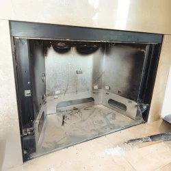 Prefabricated metal fireplace modified to accept a gas insert during installation in Collegeville, PA