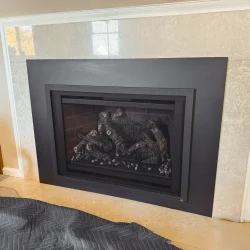 Travis 34 DVL gas insert with custom four-sided surround panel installed in a Collegeville, PA home