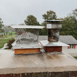 New stainless steel chimney cap installed on the masonry chimney after a wood insert installation in Norristown, PA